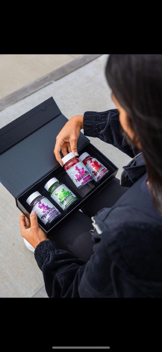 iWanna Experience Box — all four formulas opened in hands